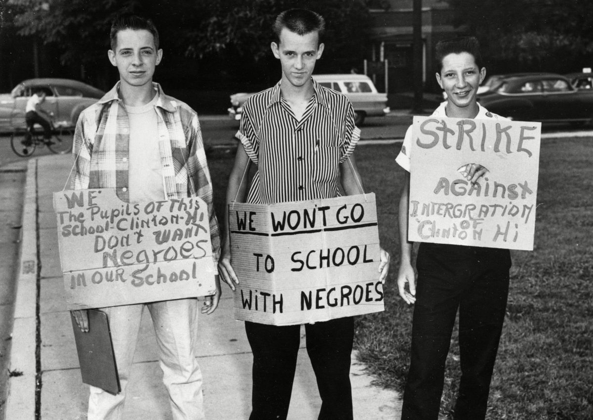 Three students at Clinton High School picket their school as it became the first state-supported school in Tennessee to integrate, . The boys are, from left, Buddy Trammell, Max Stiles and Tommy Sanders. Trammell and Sanders later discarded the pro-segregation signs and reported to classes