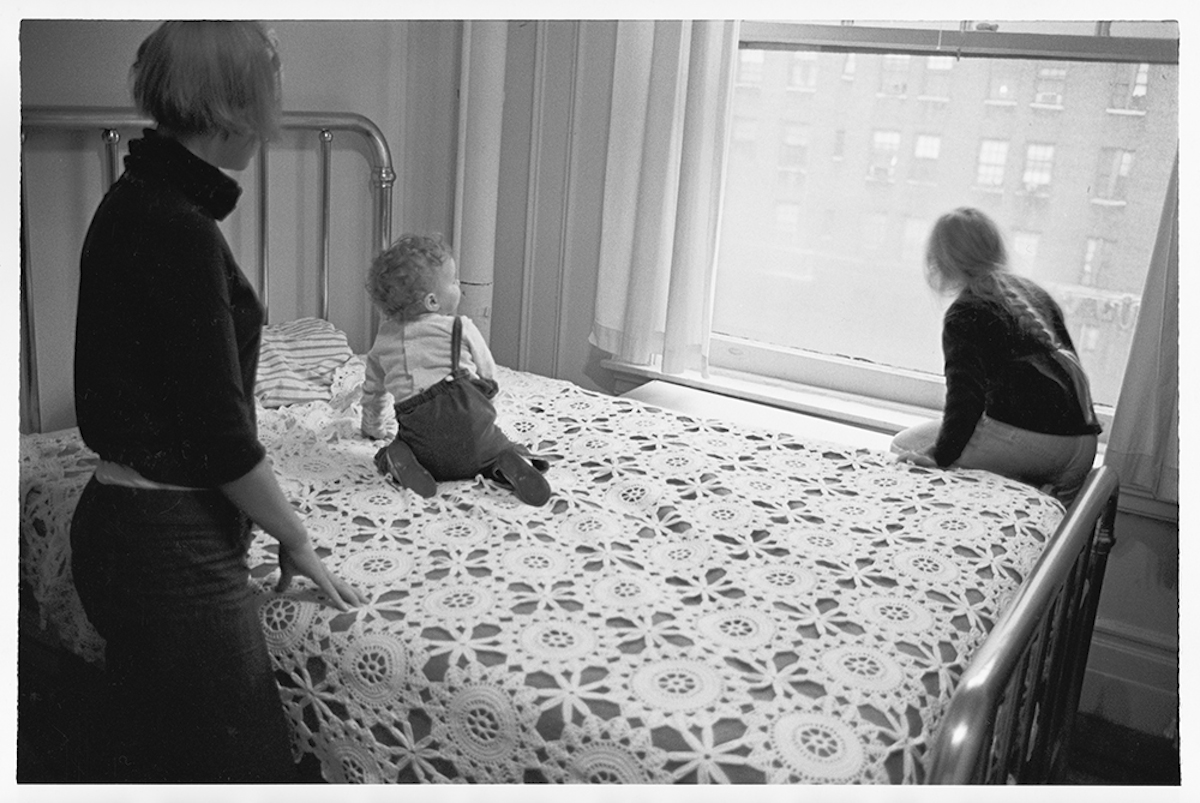 Jenny, Ulrika, and Monika on Swedish grandmotherâs bedspread looking out the window toward Broadway at West 89th Street, 1967