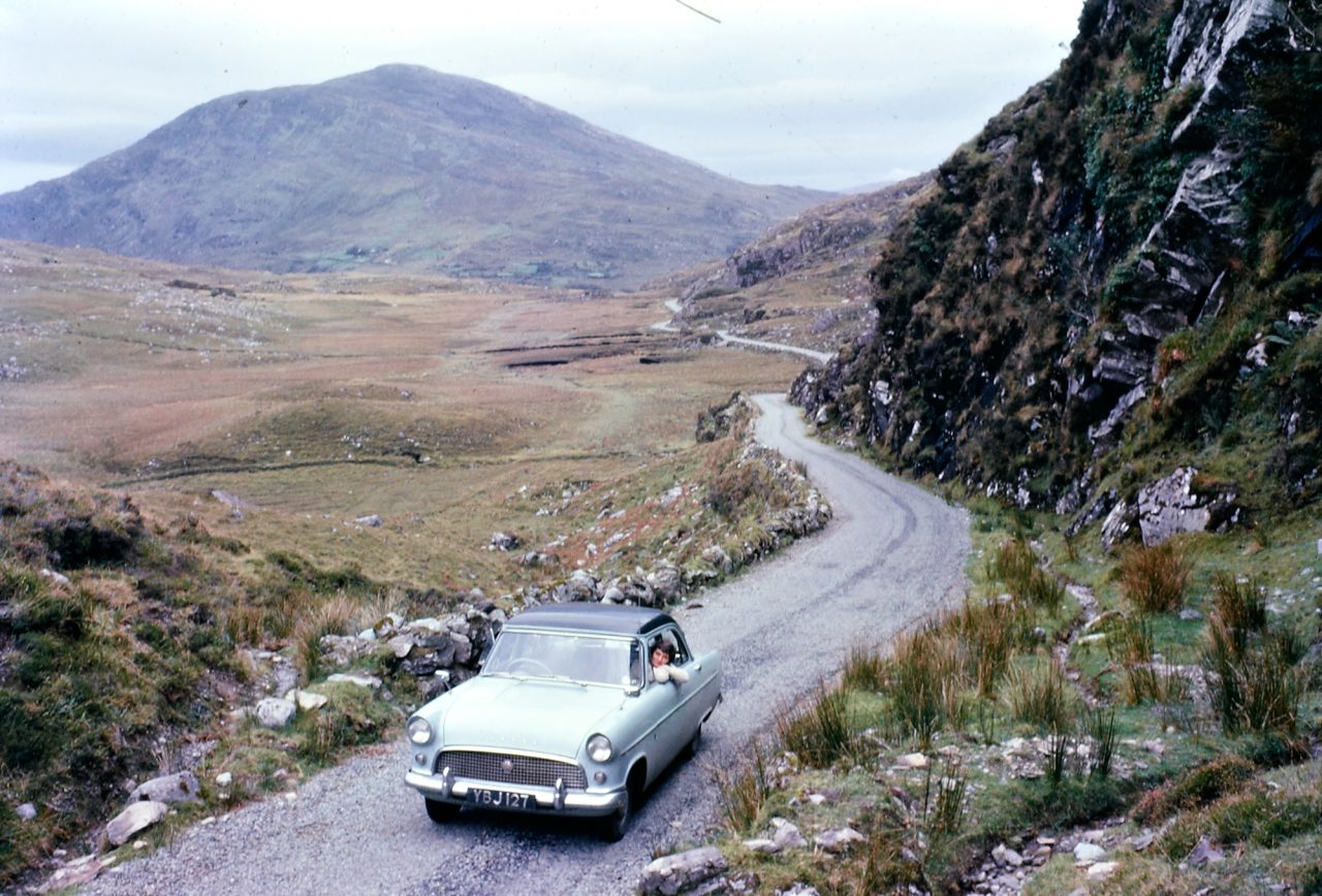 Ireland 1960s, Ring of Kerry Big challenge for you today! Though of course, every time I say that, someone solves the puzzle in 5 minutes. Anyway, we'd love to identify this exact spot… photogaff is first off the mark, suggesting: "That looks like a hundred metres or so on the Sneem side of the first lake heading towards Killarney at the brow of the Killarney lakes area" and franmol thinks this is right too. Meanwhile, DannyM8 and Niall McAuley think the woman leaning out the window is writer and naturalist Rosemary Elizabeth Tilbrook (aged about 32), wife of the photographer Richard Tilbrook. Niall also found what may be a photo of Rosemary Tilbrook taken in 1998 (white haired and smiling, a year before she died), and this lovely story about her: "The toads in Ashwellthorpe live in Ashwellthorpe Wood on the north side of Aswellthorpe Street, but their breeding pond lies to the south of the road – toads can live for up to forty years and always return to their same breeding pond, year after year. Some of you will remember that Rosemary Tilbrook who lived in Red Squirrels used to ferry toads/frogs/newts across the road for many years up until her death in 1999. There are now some 15 volunteers including youngsters with their parents in Ashwellthorpe who will come out in all weathers to help this migration." And the car has also been identified as a Ford Consul Mk II, registered in East Suffolk, England in 1958. Date: Circa 1960