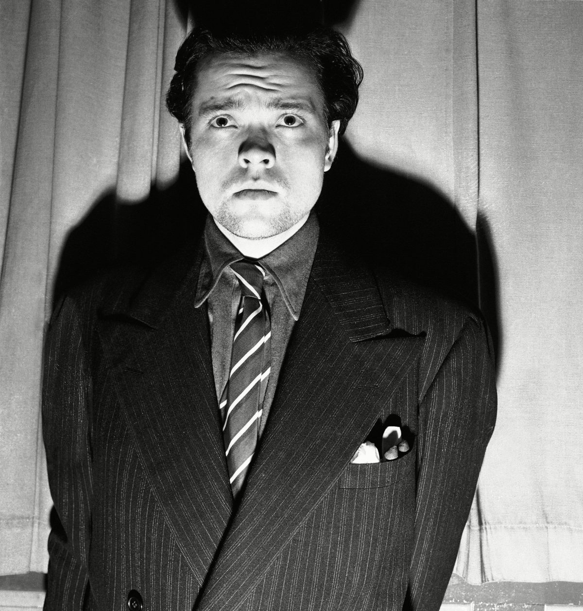 Orson Welles, radio and stage actor, whose dramatization, of an H. G. Wells novel titled "War of the Worlds" which related the "invasion" of New Jersey by a horde of men from mars was interpreted by listeners as an actual news broadcast of the events supposed to presume the end of the world. Panicked listeners fled into streets to get away from the invaders: radio and police stations were swamped with calls all over the country - the broadcast was nation - wide (CBS) - and in Newark 15 persons were treated for shock after they rushed out of their homes to escape what appeared to be certain doom. Welles is after the broadcast Orson Welles