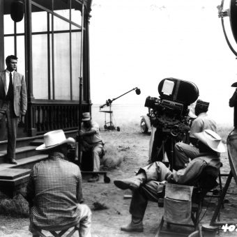 Director George Stevens (center, white hat), seated with cameraman and ...