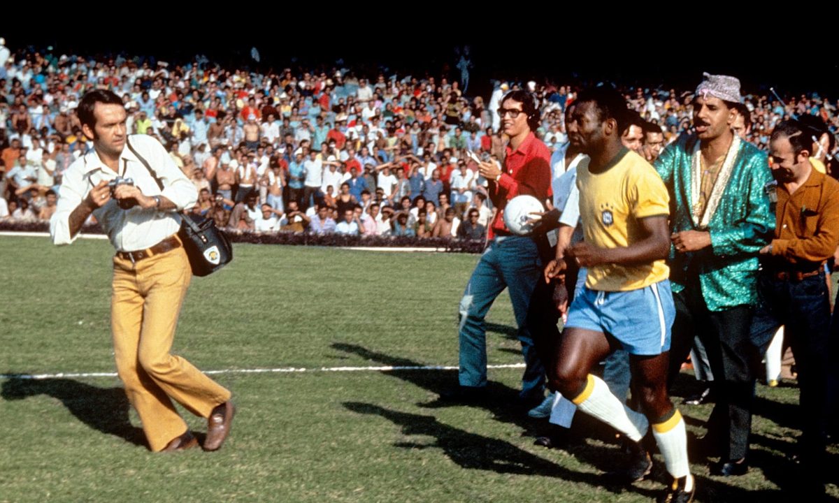 Pele is surrounded by photographers before the 1970 World Cup final against Italy. Photograph: Peter Robinson/EMPICS Sport