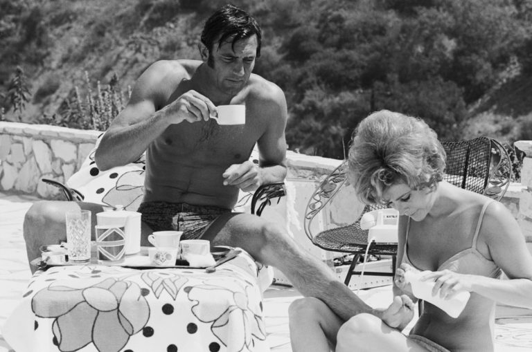 George-Lazenby-and-Jill-St-John-spreading-sun-cream-1965-%C2%A9-Terry-ONeill-768x509.jpg
