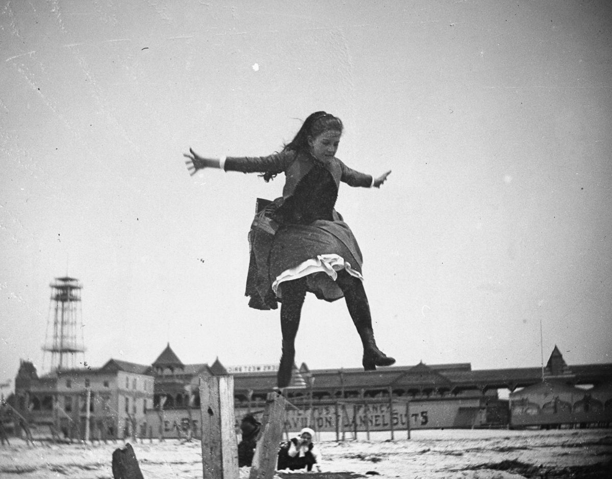 May 15, 1887 Edith Poey jumps off a wooden pole onto the sand at Coney Island.