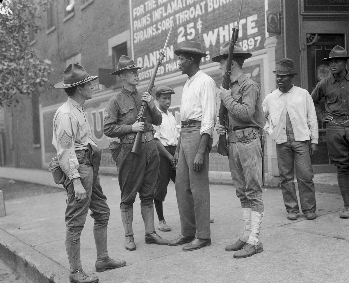 Illinois-National-Guard-soldiers-questioning-a-tall-black-man.jpg