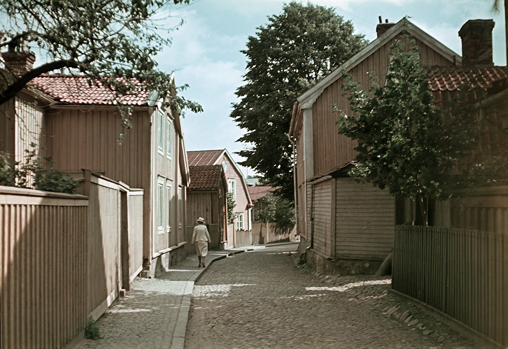 A woman walking in Västerlånggatan street.