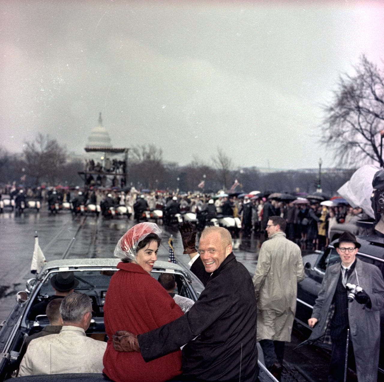 Mercury astronaut John Glenn and his wife, Annie, ride in the back of an open car with Vice-President Johnson during a parade in Glenn's honor in Washington.