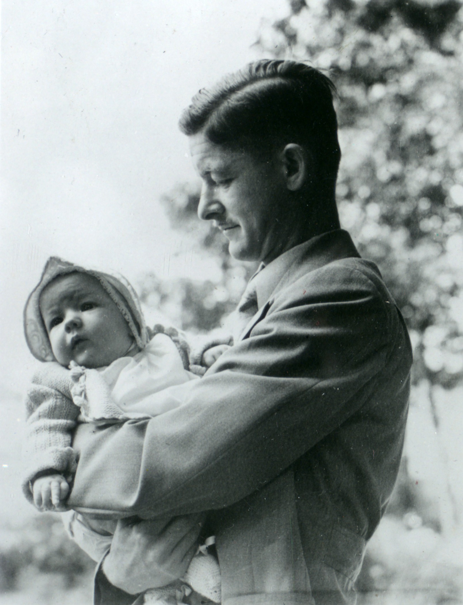 Photograph of Jim Havens holding one of his children