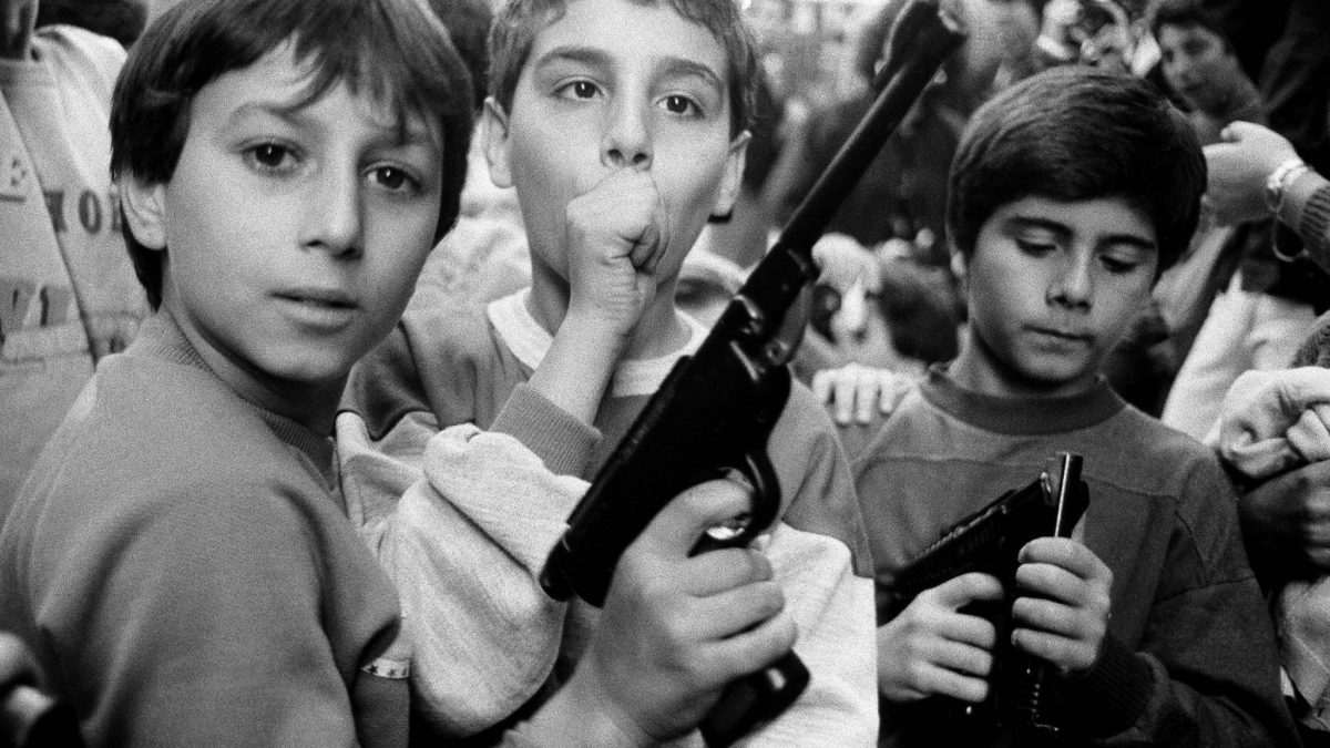 Three young boys holding guns mafia Sicily Italy 