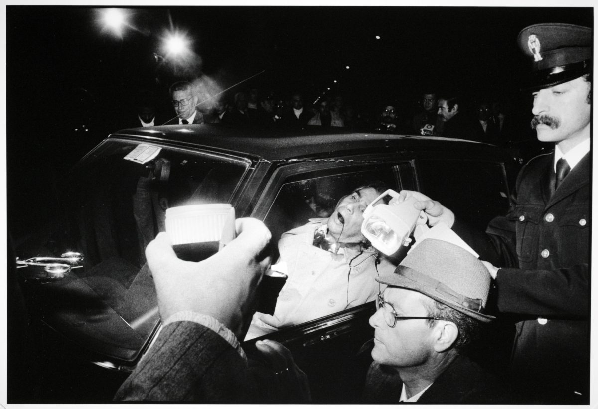 Police and journalists surround a dead body in a car mafia Sicily Italy 