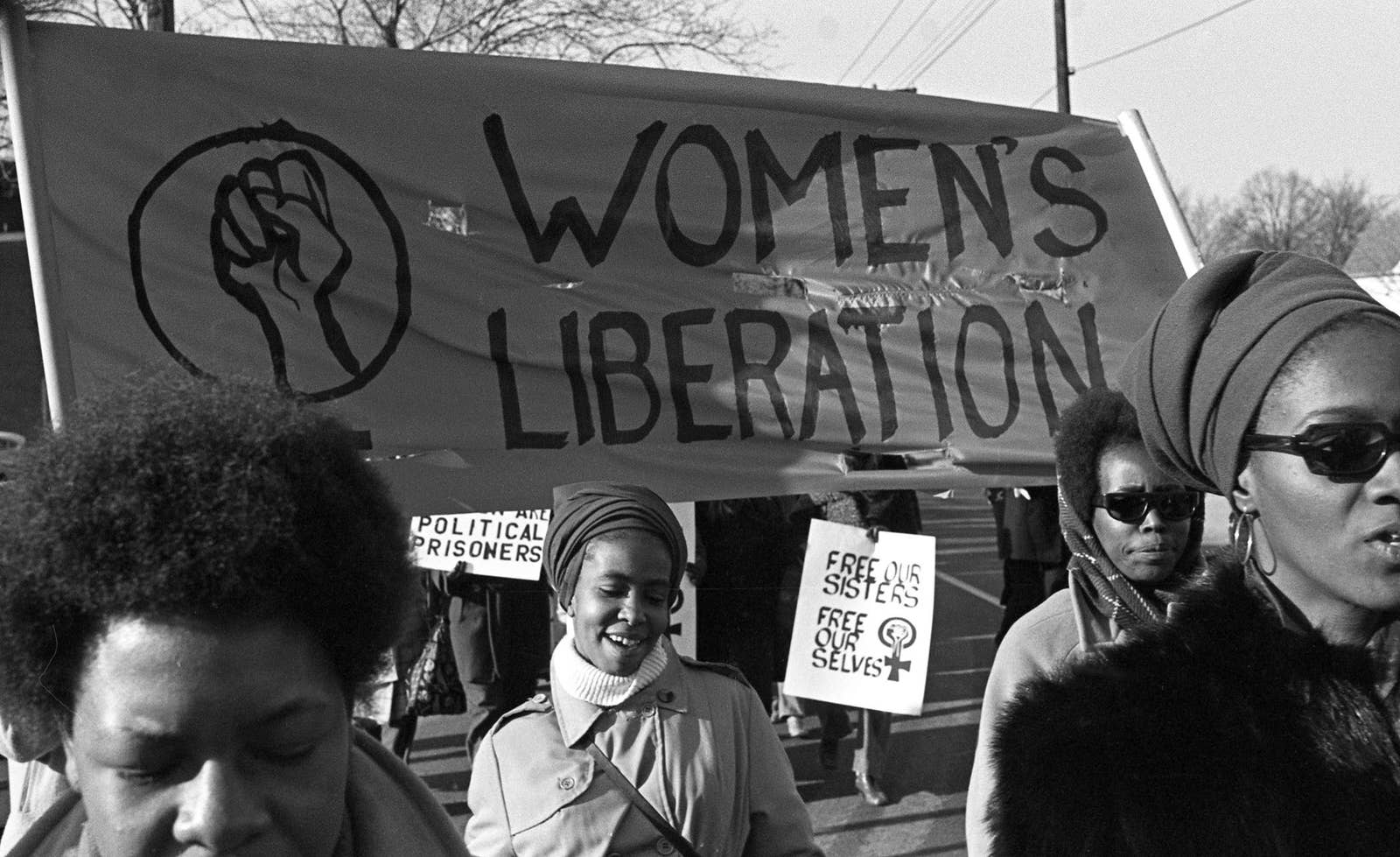 A group of women, under a Women's Liberation banner, march in support ...