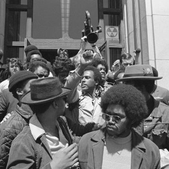 Huey Newton (center) gives the Black Power salute as he leaves Alameda ...