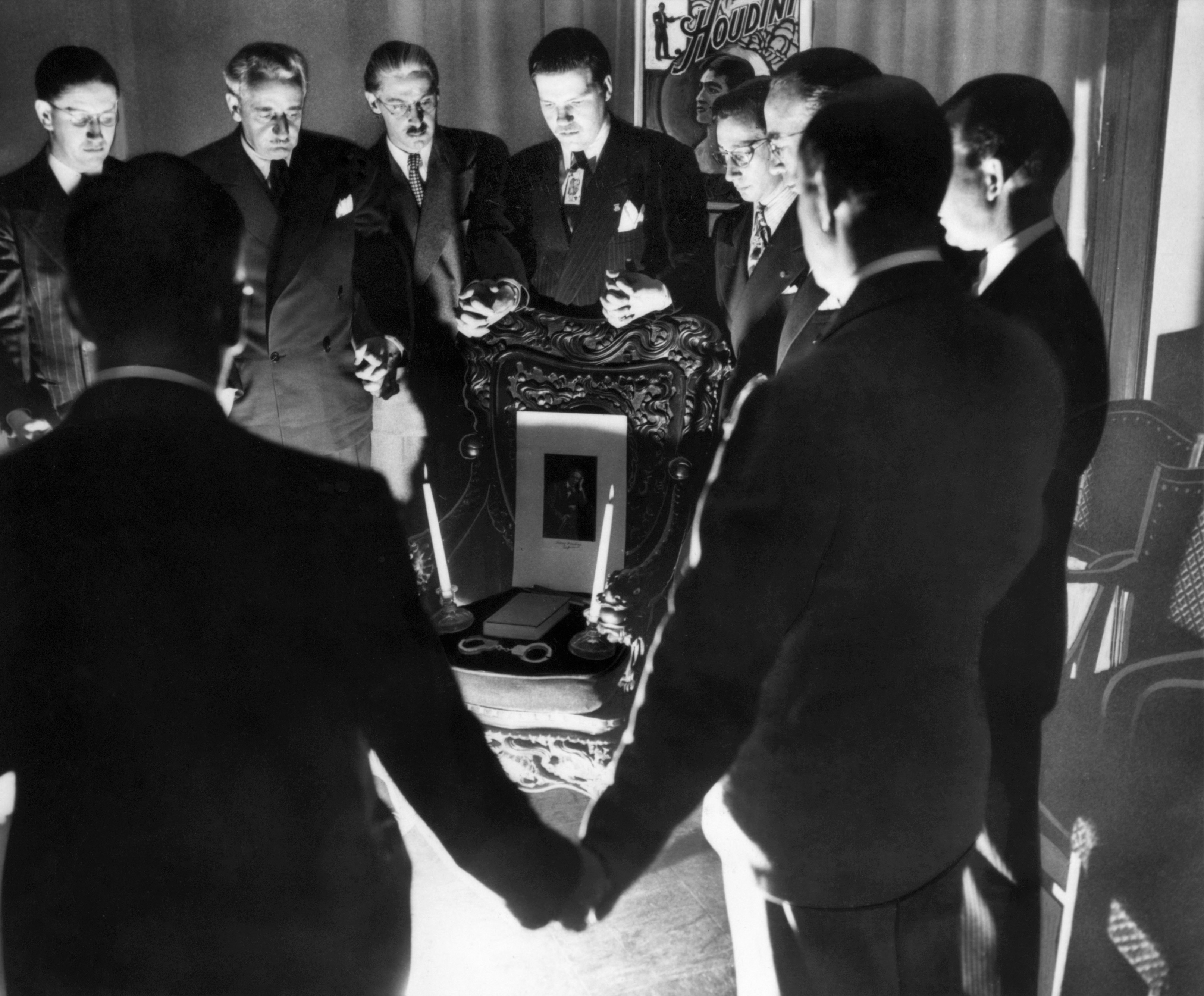 Houdini Seance, 1936. A Group Of Magicians Conducting A Seance In Detroit, Michigan, In An Attempt To Contact The Spirit Of Harry Houdini. Photograph, 31 October 1936.