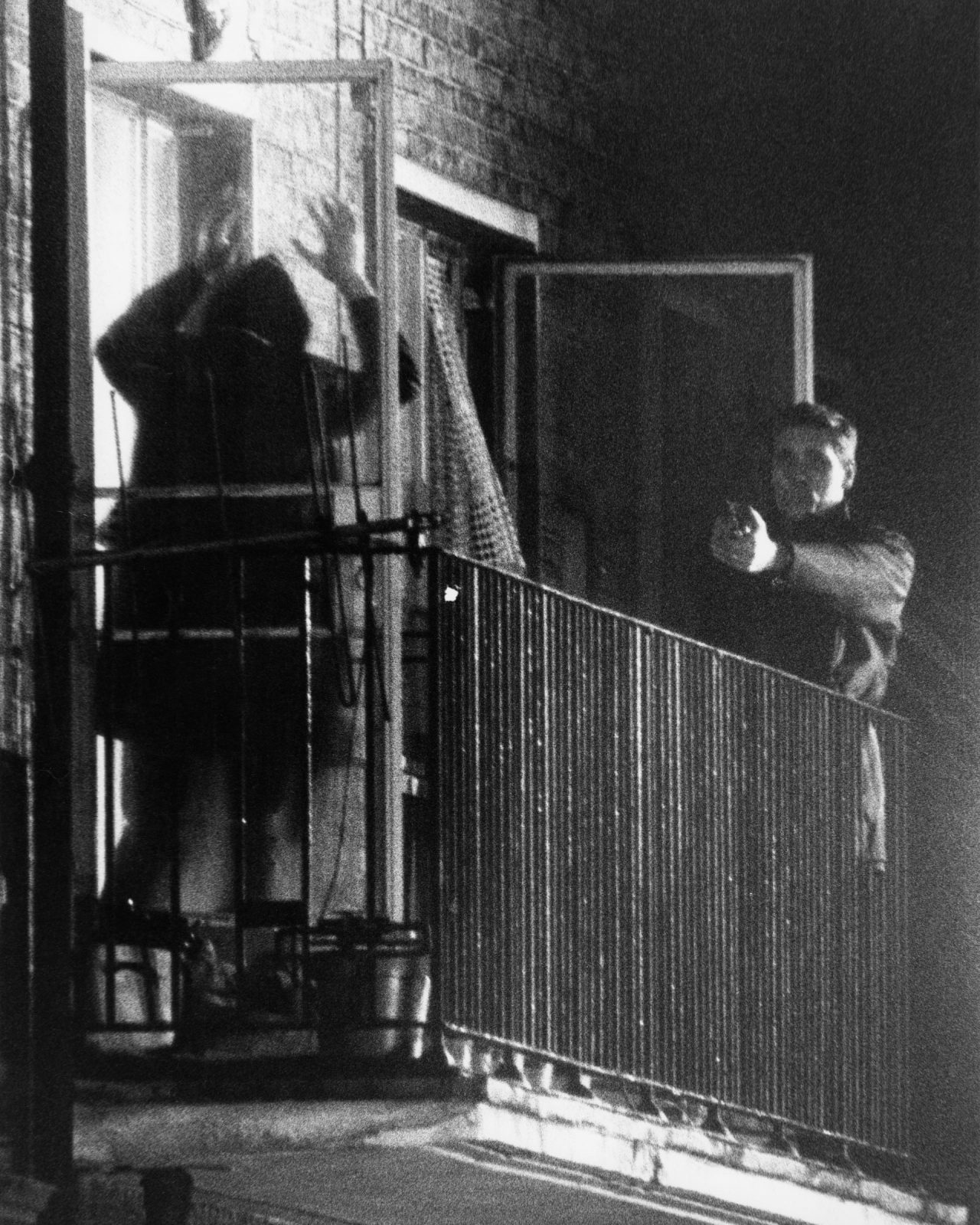 A member of the IRA surrenders to police at a flat at 22b Balcombe Street in Marylebone, London, at the end of the Balcombe Street Siege, 13 December 1975