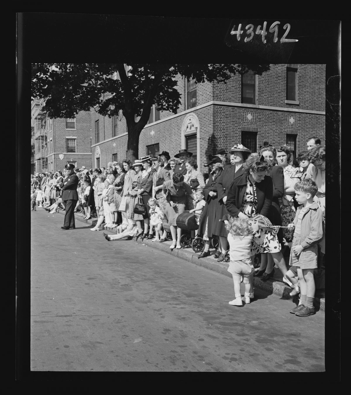 Title: Brooklyn, New York. Crowds watching the Anniversary Day parade of the Sunday school of the Church of the Good Shepherd Creator(s): Hollem, Howard R., photographer Date Created/Published: 1944 June.