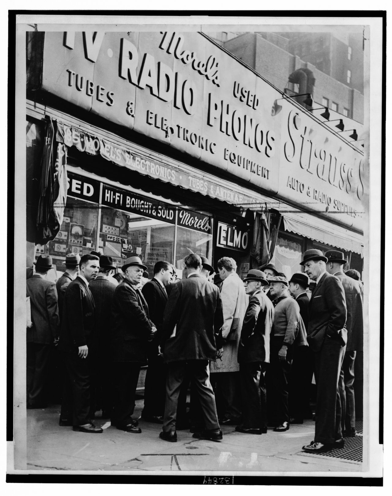 Title: Crowd listens outside radio shop at Greenwich and Dey Sts. for news on President Kennedy / World Telegram & Sun photo by O. Fernandez. Creator(s): Fernandez, Orlando, photographer Date Created/Published: 1963 November 22.