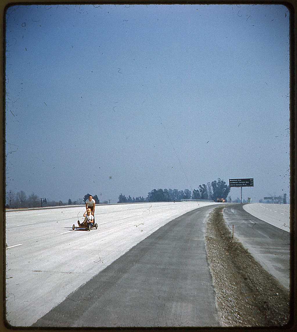 Jim Stephenson February 8 · This slide will mean little to anyone besides an Angeleno: two teenagers ride their go-kart on the empty Ventura Freeway (the 101). The freeway opened in April, 1960, and although it's undated I think the slide must have been taken about then. The sign in the distance tells us that this view was taken looking southbound, since the upcoming exits are Woodman, Coldwater Canyon, and Laurel Canyon.