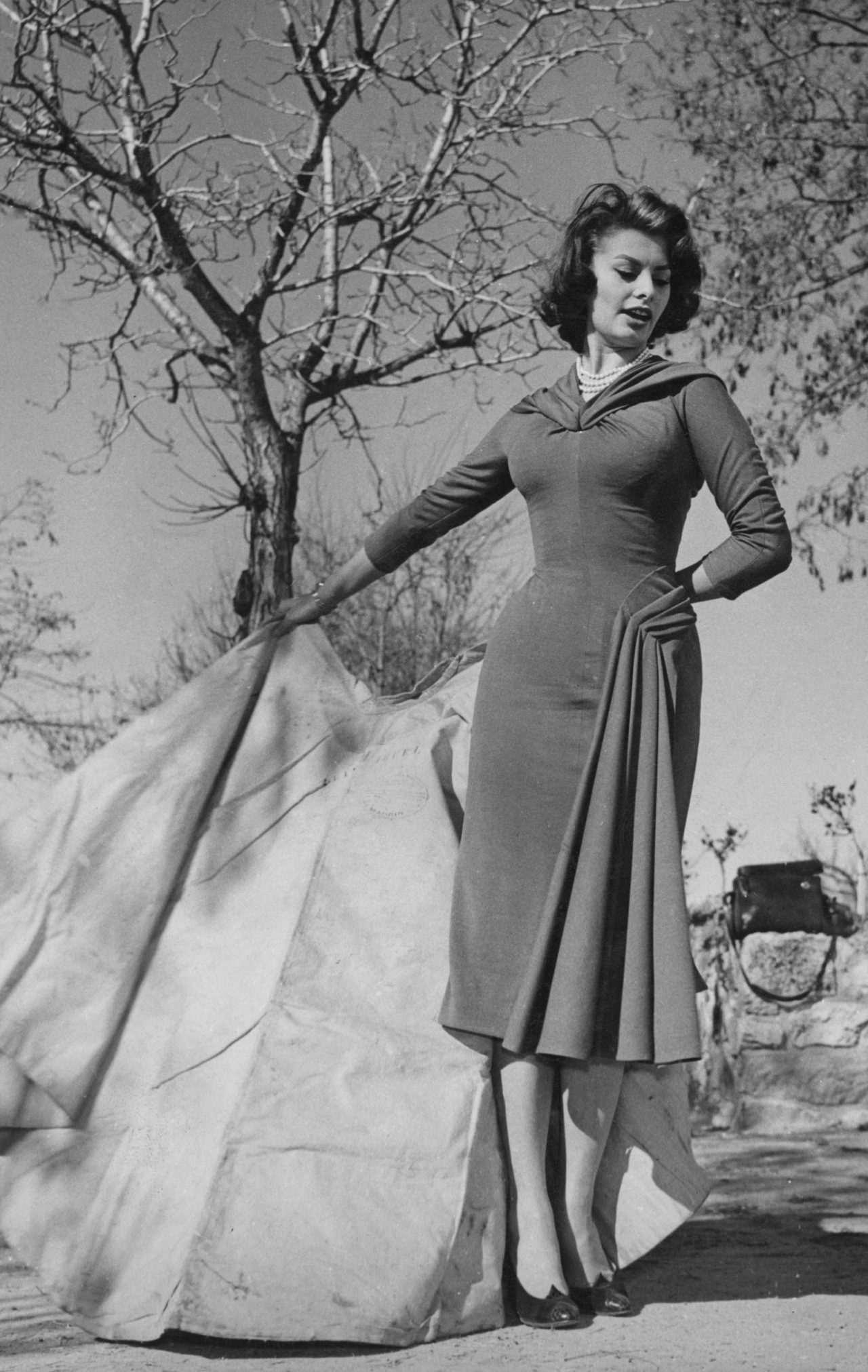 Sophia Loren holds a red cape during a lesson from famous bullfighter Luis Miguel Dominguin at his private training ring at the Villa Paz near Madrid, Italy on February 10 1956 image