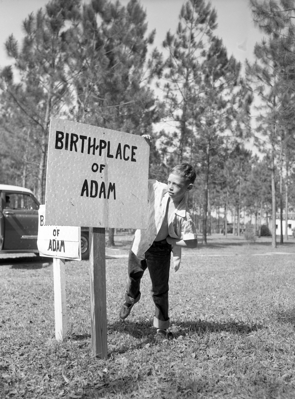 Joe Kerce reading sign marking the "birthplace of Adam" in the Garden of Eden