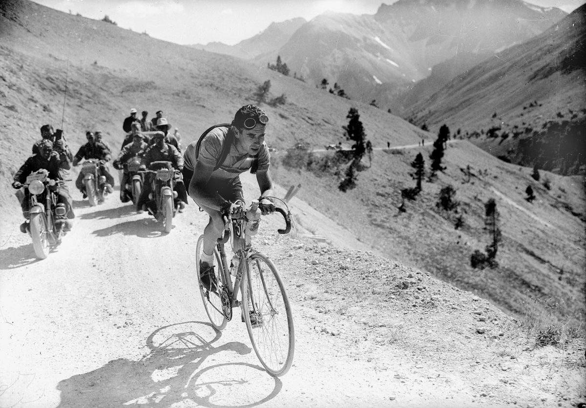1936 Tour de France photo, cyclists racing on gravel road