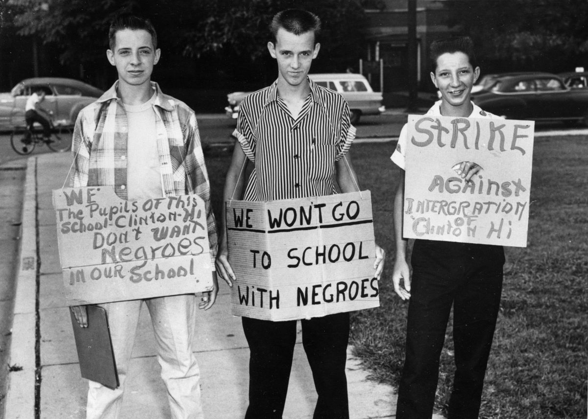 Three students at Clinton High School picket their school as it became the first state-supported school in Tennessee to integrate. The boys are, from left, Buddy Trammell, Max Stiles and Tommy Sanders. Trammell and Sanders later discarded the pro-segregation signs and reported to classes. Date: 27/08/1956