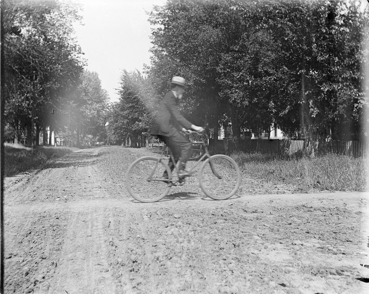 Man riding a bicycle - George Silas Duntley Photographs 1899-1918