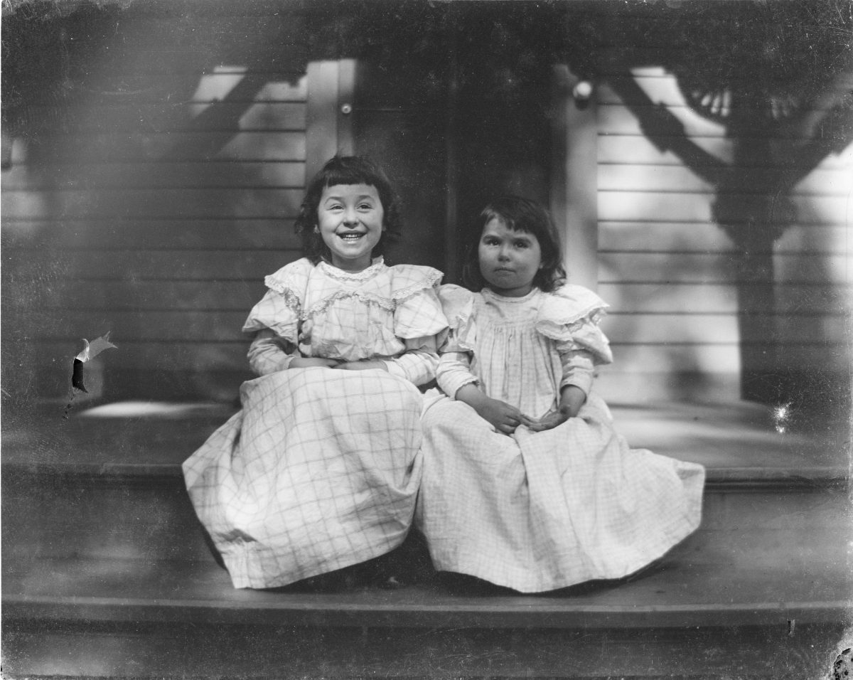 Two girls sitting on front porchGeorge Silas Duntley Photographs 1899-1918