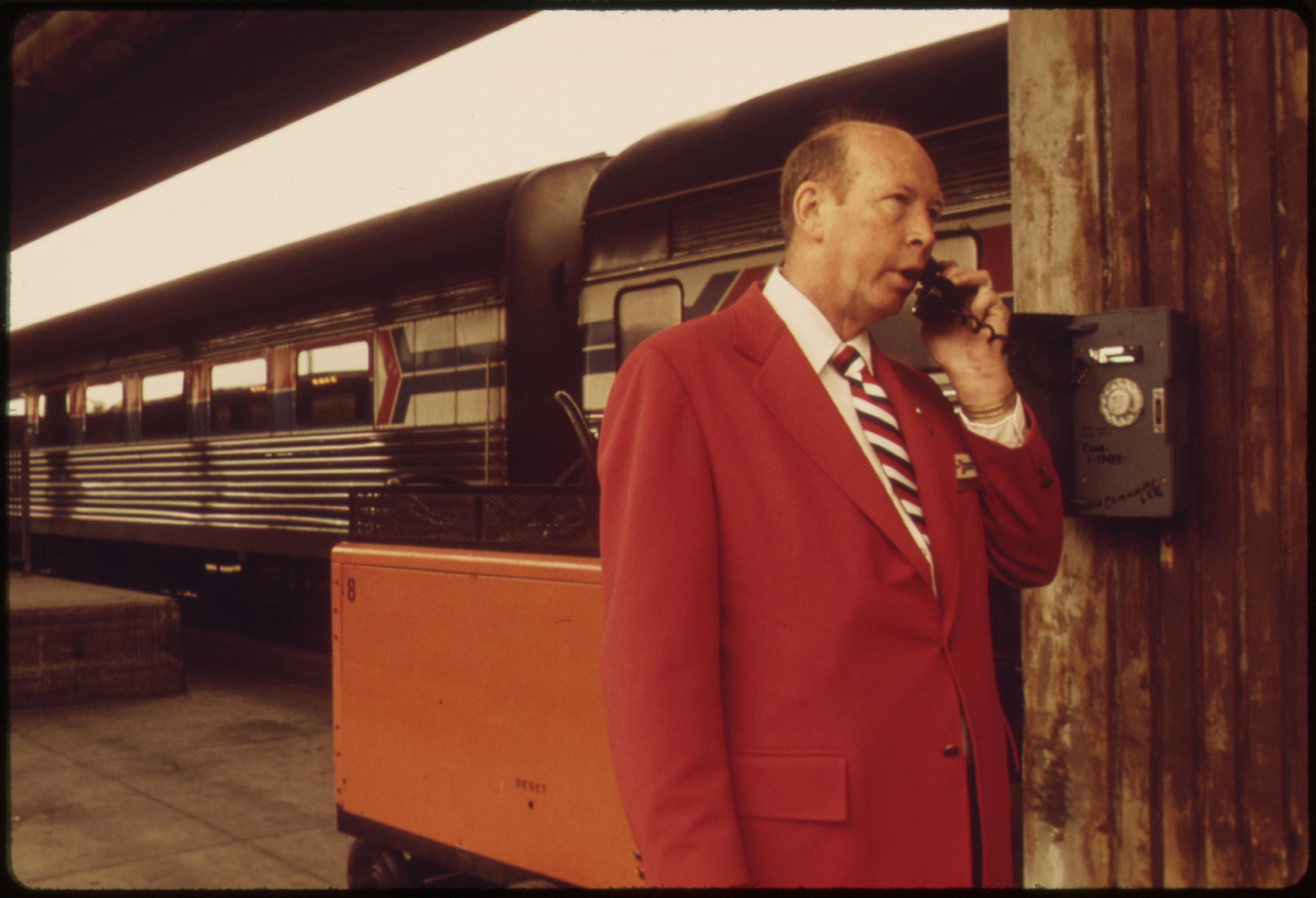 Amtrak employee checks with the station at the Los Angeles Union Passenger Terminal, May 1974 