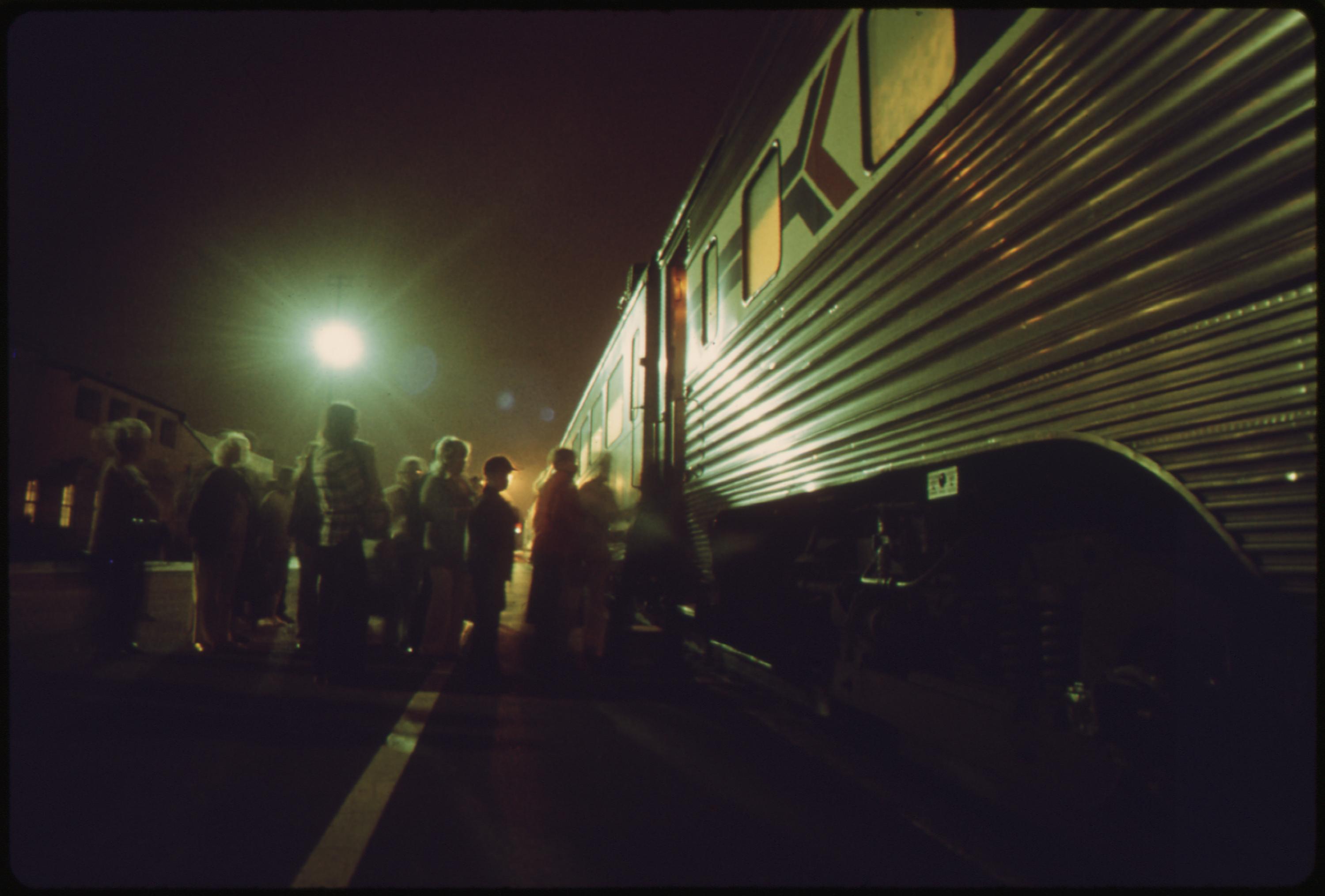 Amtrak passengers board the southbound san diegan as it makes a nighttime stop at the Fullerton, California, station, May 1974