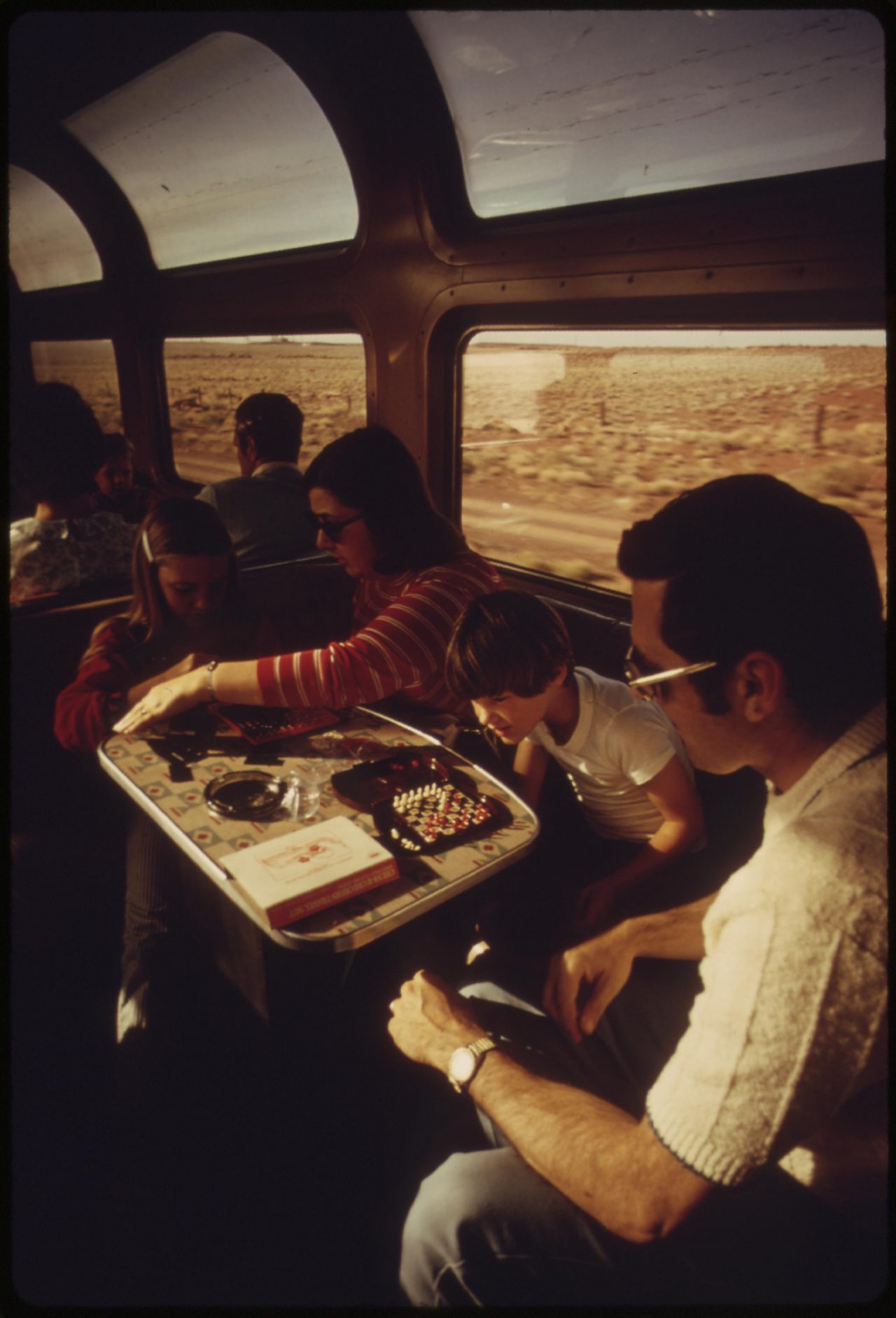 Lounge car on the Southwest Limited Amtrak train helps a family pass the time, June 1974
