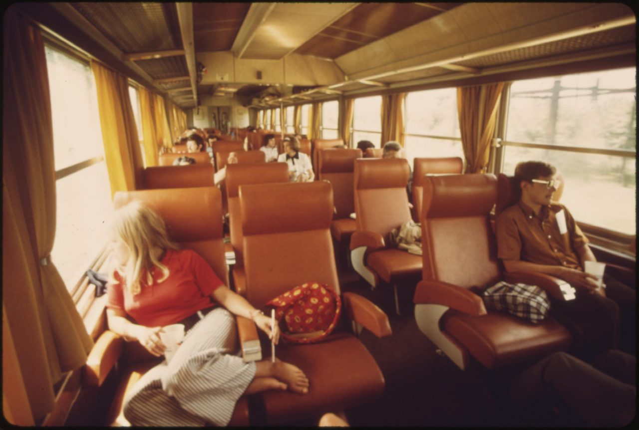 Passengers view the scenery between St. Louis, Missouri, and Chicago, Illinois, on the Amtrak turboliner, June 1974