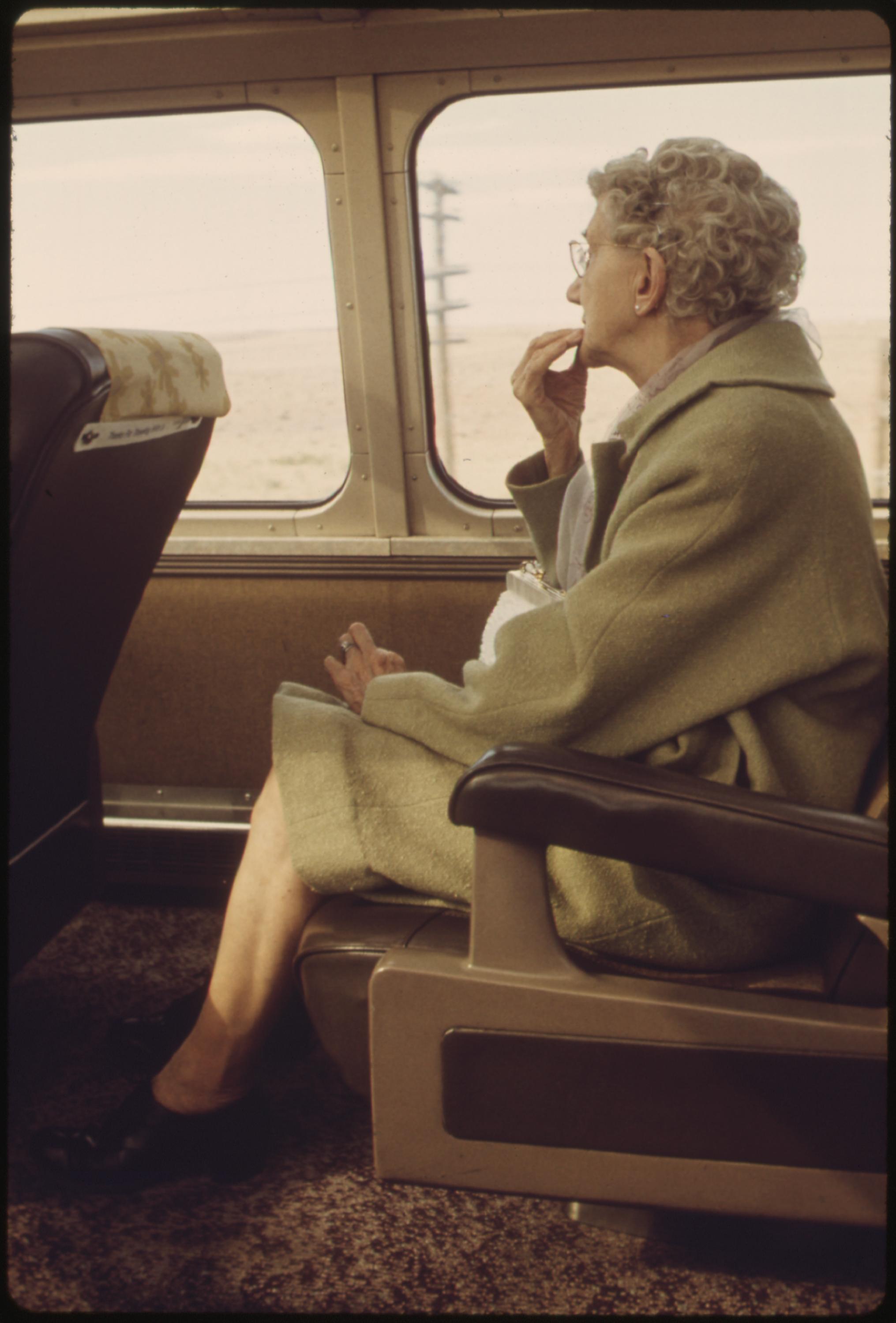 Scenery on the Southwest Limited attracts an elderly passenger on an Amtrak train between Los Angeles, California, and Albuquerque, New Mexico, June 1974