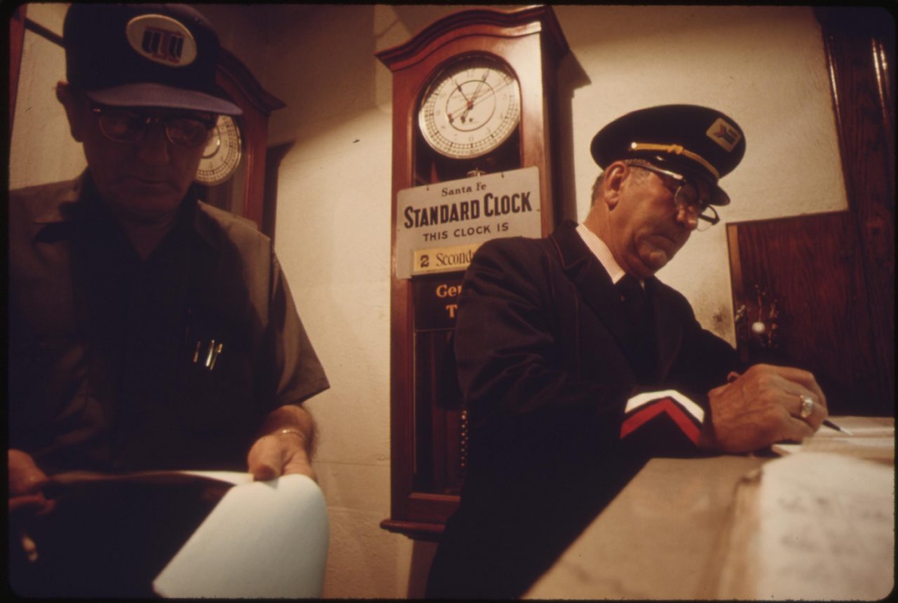 Train engineer, left, and conductor check in at the Dodge City, Kansas, station prior to boarding Amtrak's Southwest Limited which runs between Los Angeles, California, and Chicago, June 1974