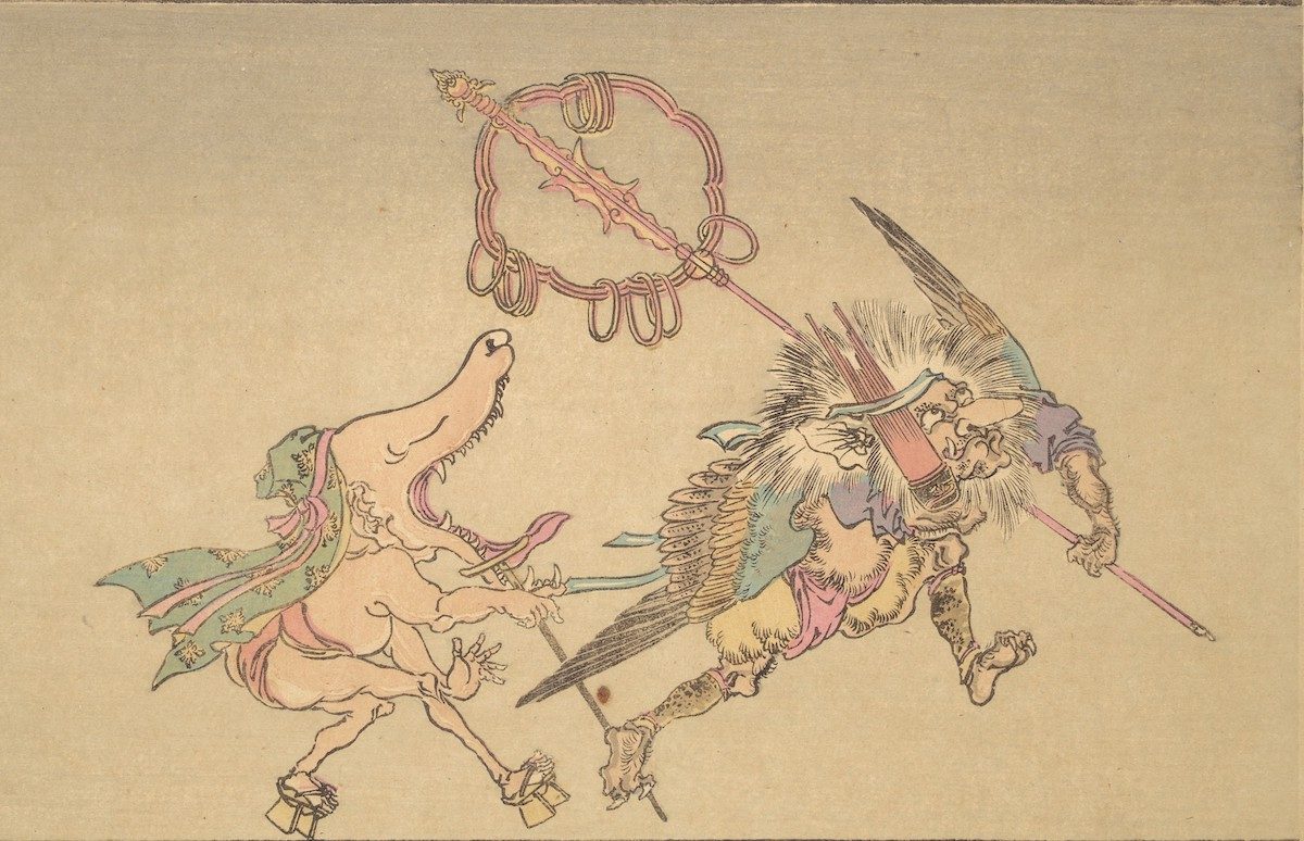 At right, a demon with a large nose and wings (tengū) carries panpipes (shō) and a pilgrim’s staff. His servant follows in wooden clogs (geta), with a wolf-like head and gaping mouth.