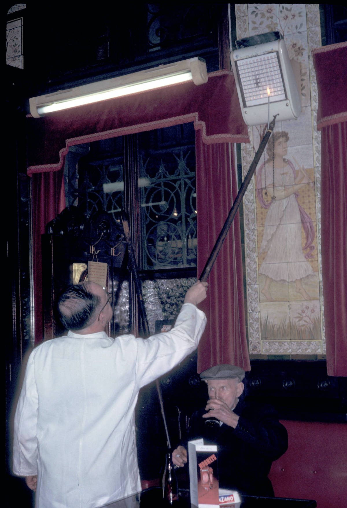 Dublin, man adjusting gas heater at Bruxelles Bar 1964