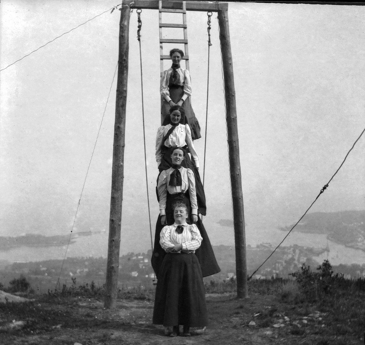 Friends and family of Theresa Babb perched on a ladder by the Summit House swing on August 17, 1898.