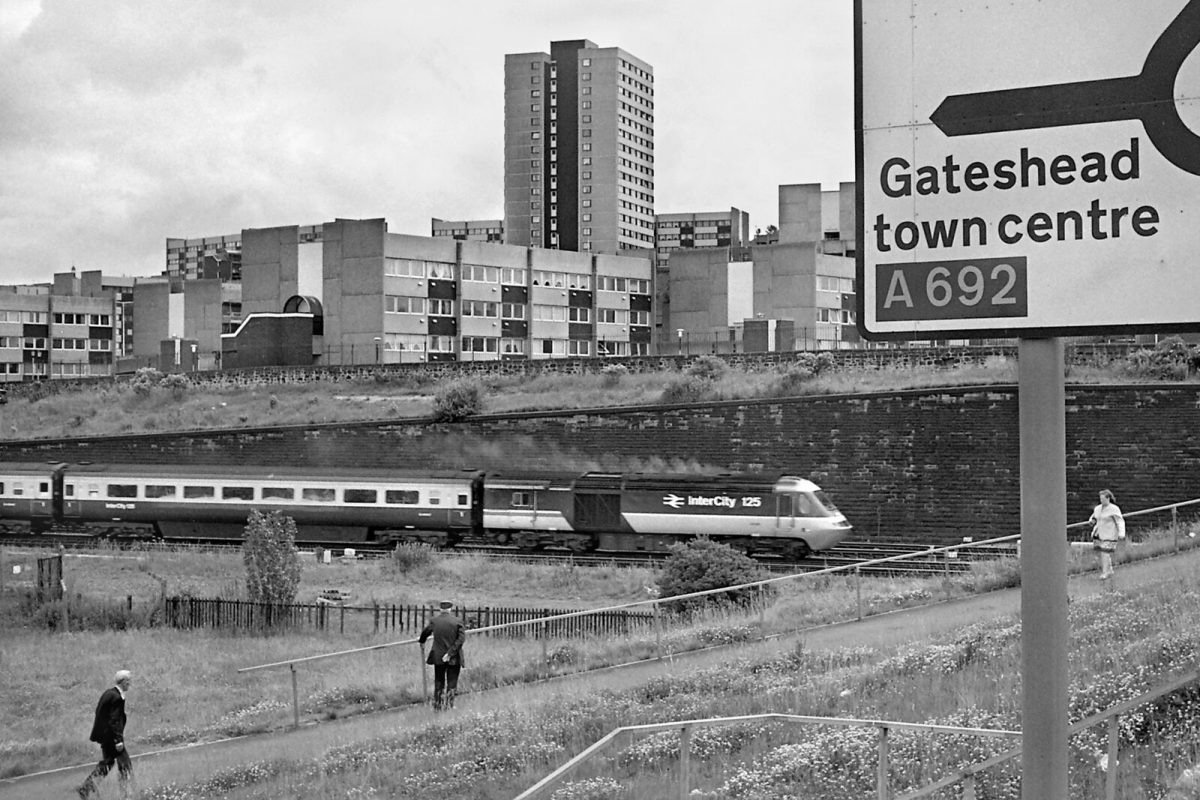 An InterCity 125 train heads south past St. Cuthberts Village in 1987.
