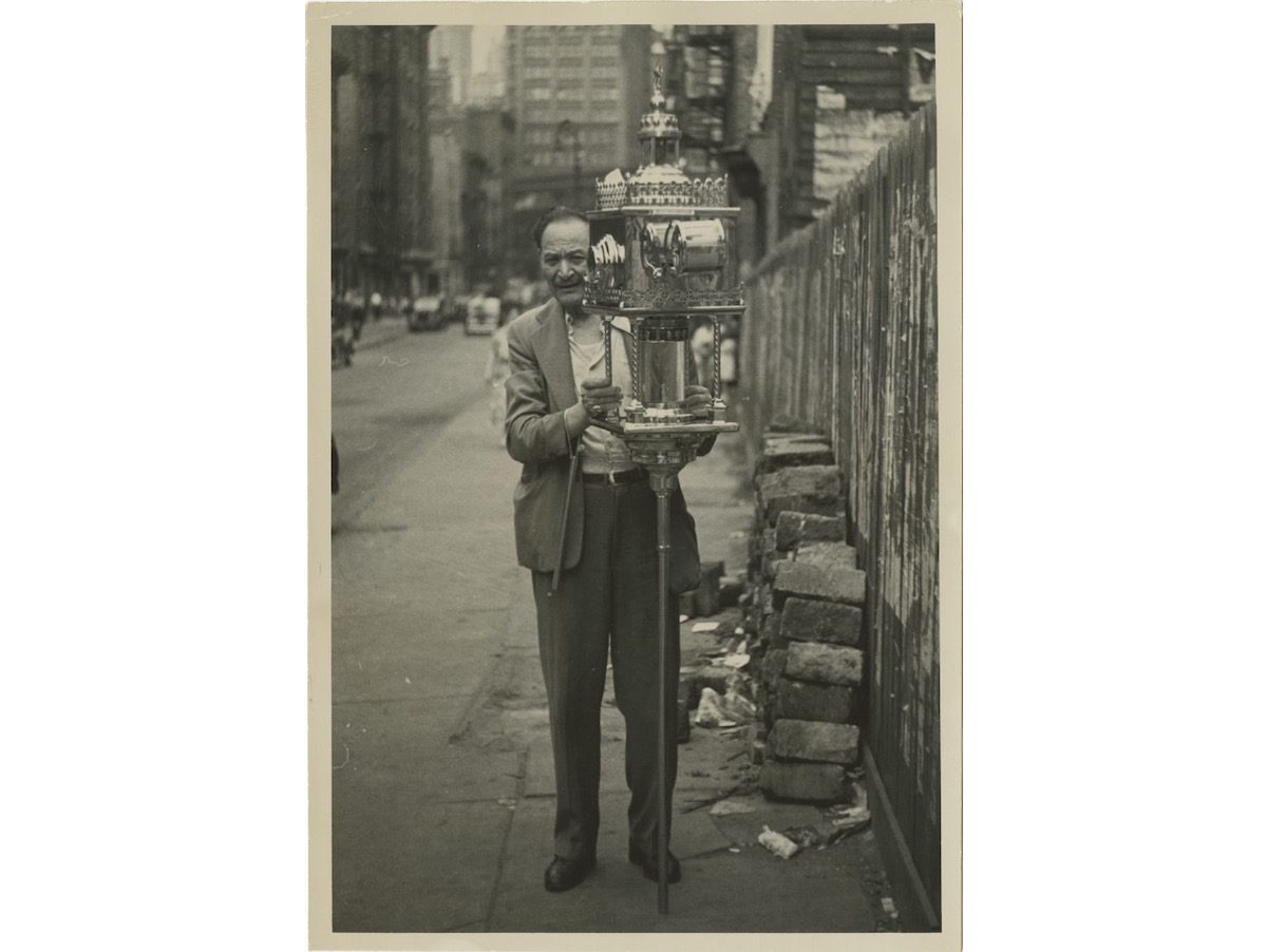 A sidewalk fortune teller near Chatham Square on the Lower East Side. 1947