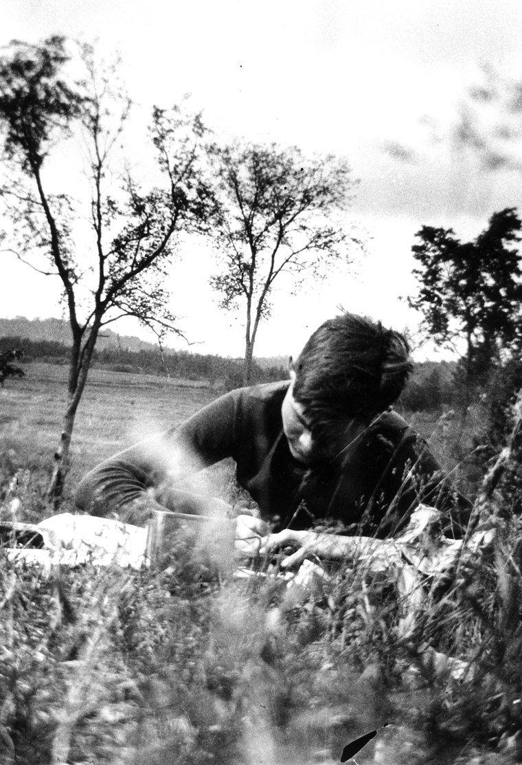 Description: Ernest Hemingway writing while on a fishing trip in Michigan. Credit Line: Ernest Hemingway Collection. John F. Kennedy Presidential Library and Museum, Boston. Date: 1916