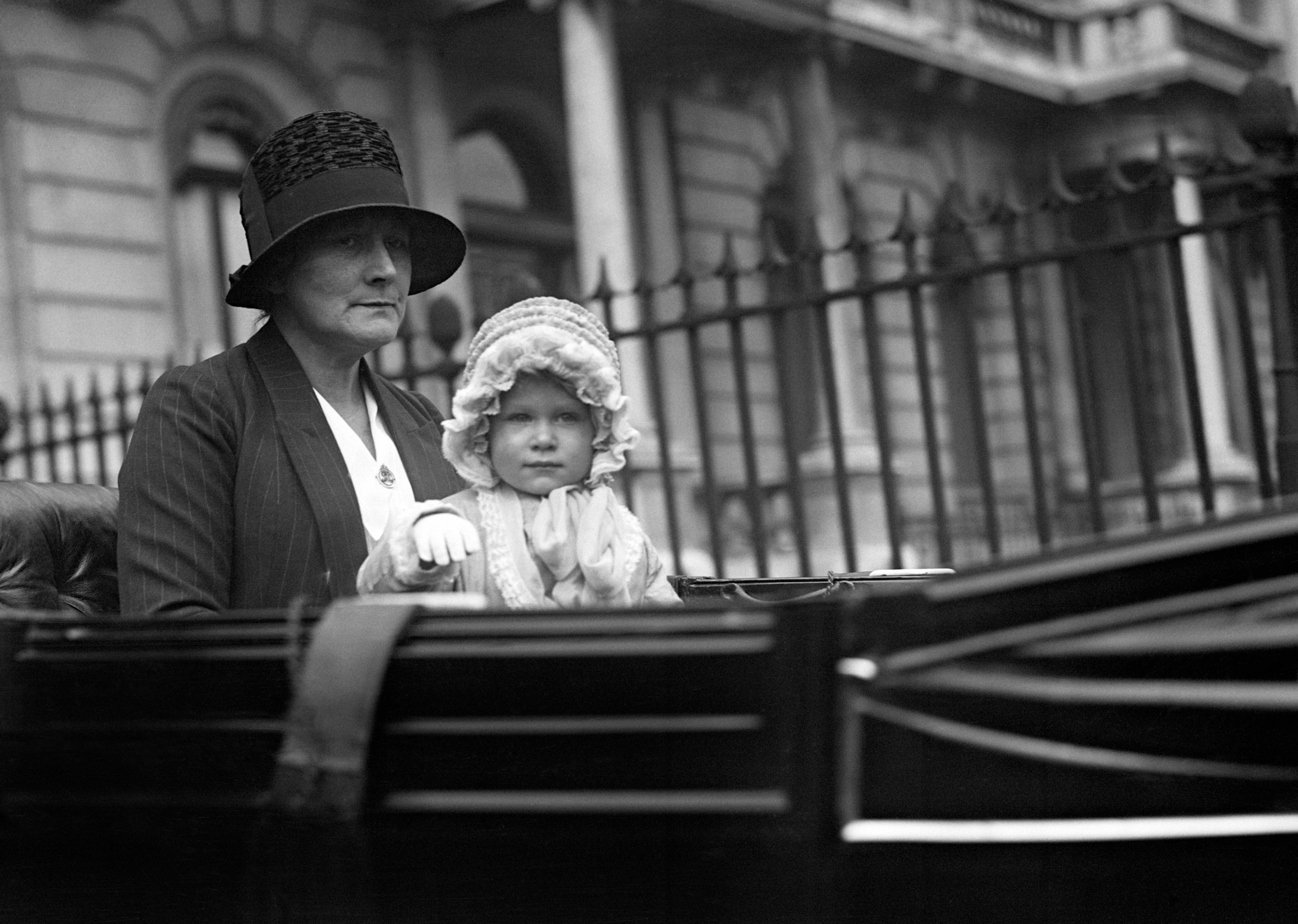 Little Princess Elizabeth waves at the crowds on Picadilly as she makes her way home from a carriage ride around Hyde Park