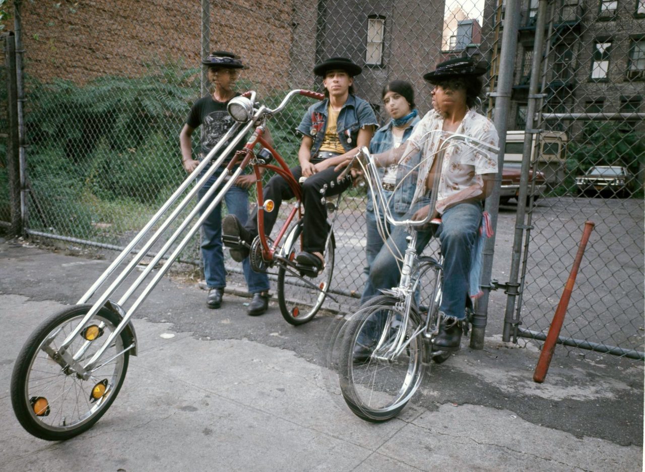 Bikers E 3rd St 1975 - © Rich Allen As I said hold still at 1:15 ? shutter speed, the two at ends both turned to look at their leader on the big bike in the center to see if he held still.