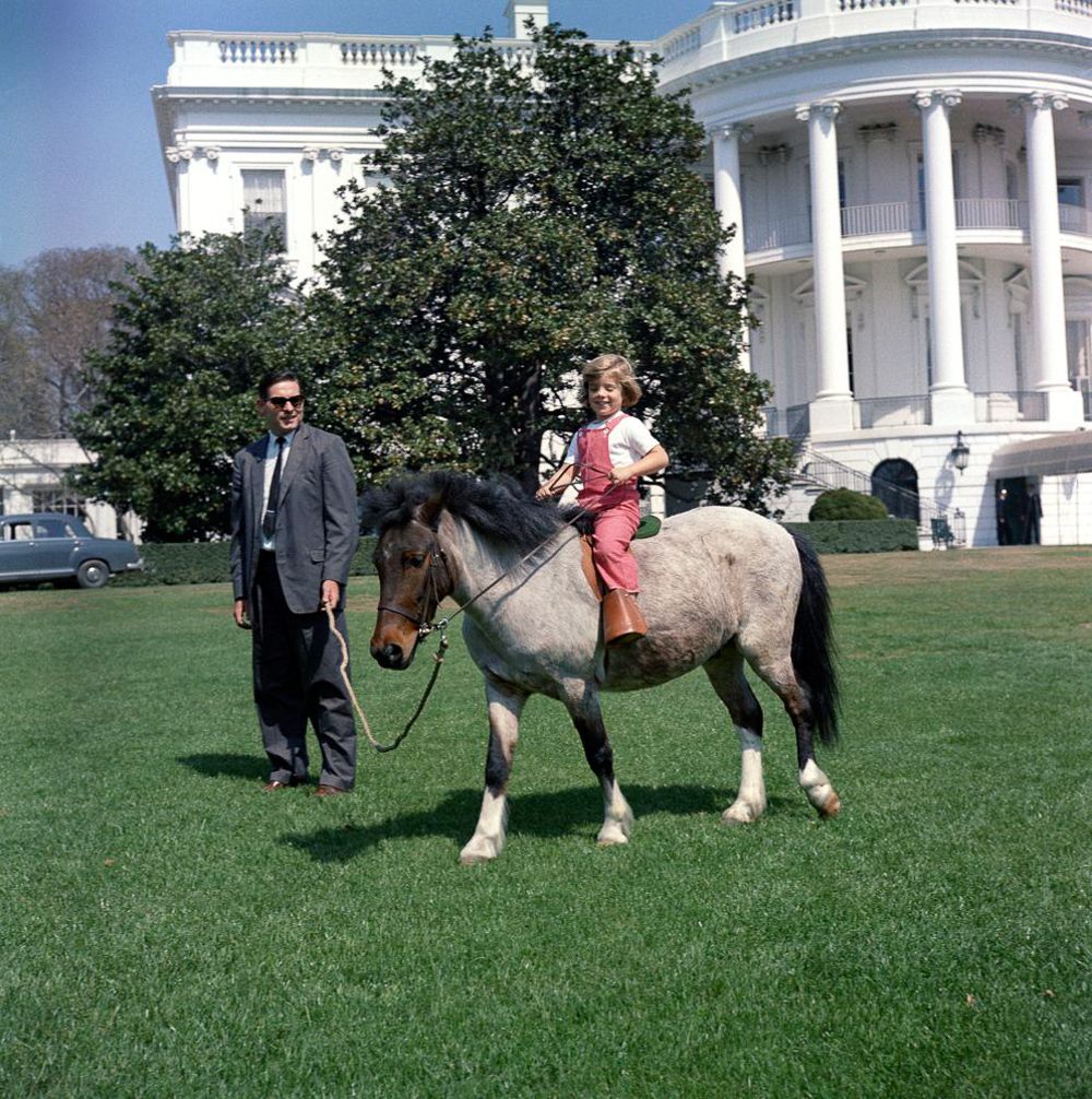 March 30, 1962 Secret Service agent Bob Foster leads Caroline Kennedy on a ride with Macaroni.