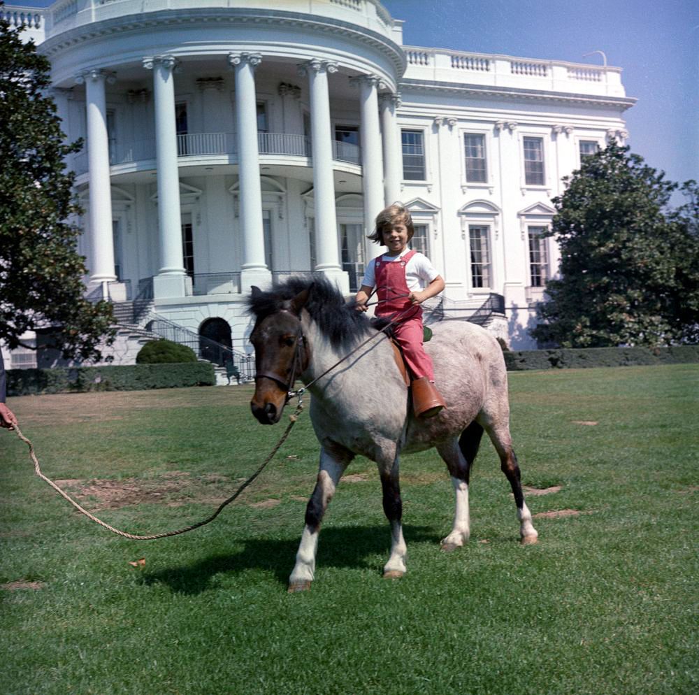 March 30, 1962 Secret Service agent Bob Foster leads Caroline Kennedy on a ride with Macaroni.