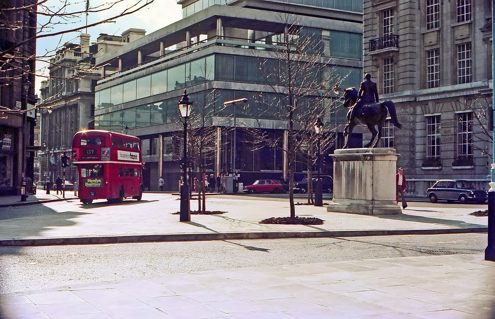En route to West Hampstead, LT Routemaster No. RM95 passes the bronze equestrian statue of George III at the junction of Cockspur Street and Pall Mall. 19th April 1975.