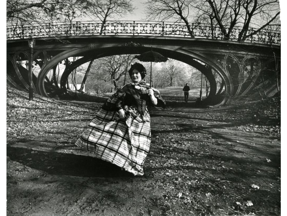 Central Park Gothic Bridge (designed 1860). Gothic bridge at north end of Central Park bridal path, near 93rd Street. Model in 1860 crinoline taffeta skirt and cap sleeve bodice. 