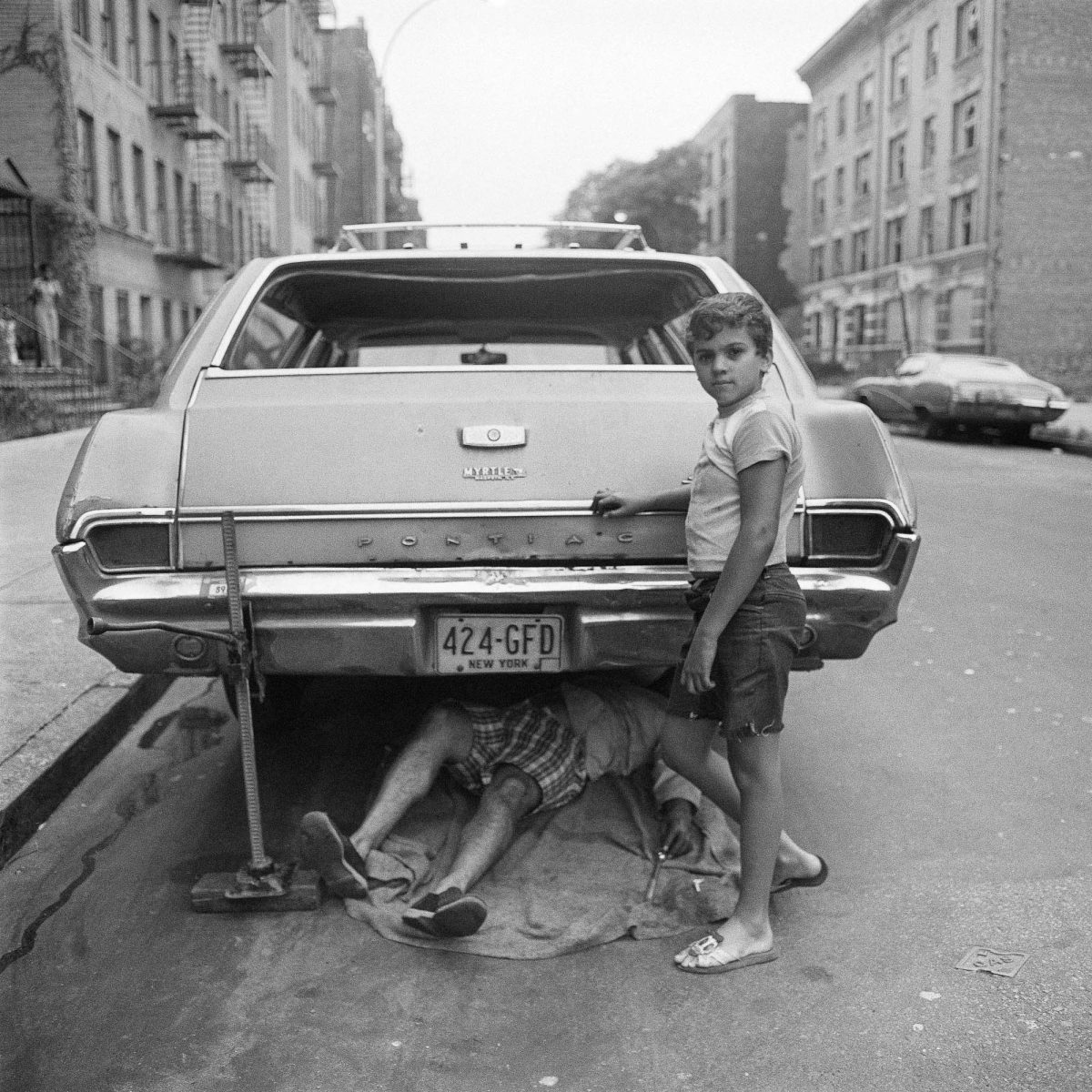 “Fixing Car Jacked Up on Beck St” (1978). The Bronx, New York