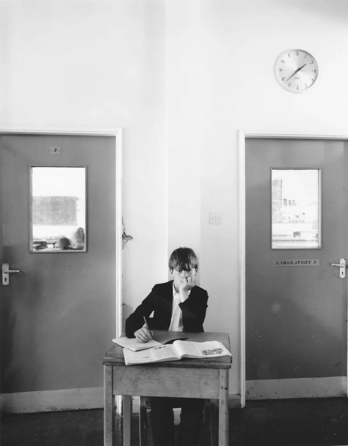 Lee, working on science copy book in the corridor outside the science lab, East Cleveland, 1986