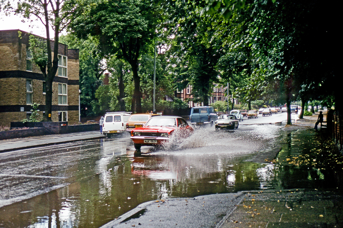 A 1976 Ford Cortina Mk. III negotiates a flash flood following a heavy rain storm on 12th August 1979.