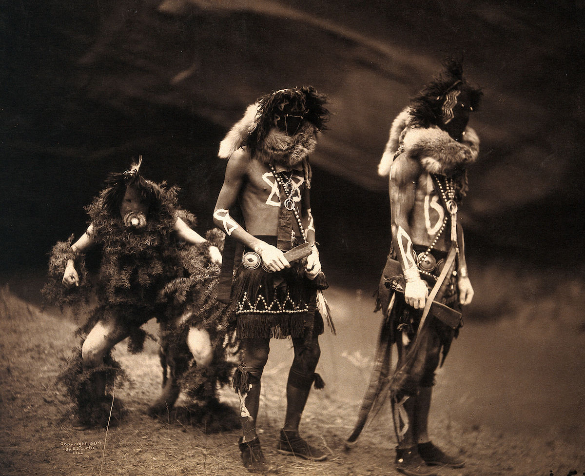 Three Navajo men proceeding as war gods- Tonenili, Tobadzischini and Nayenezgani. Photograph by Edward S. Curtis, 1904. Curtis, Edward S., 1868-1952. Date- 1904