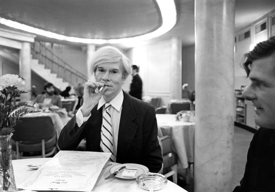 Robert Levin, Andy Warhol seated at a table at the Pierre Hotel in New York City (1981). Photo- courtesy Maison Gerard.